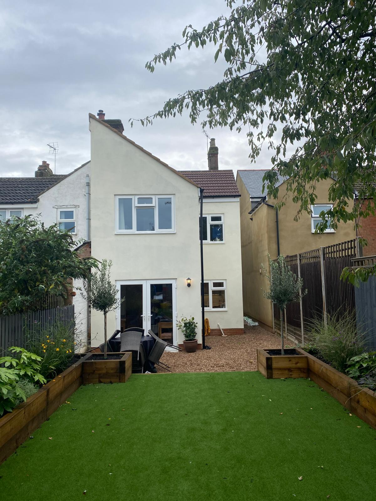 Two storey rendered rear extension with French doors and landscaped garden by DBD Builders Ltd