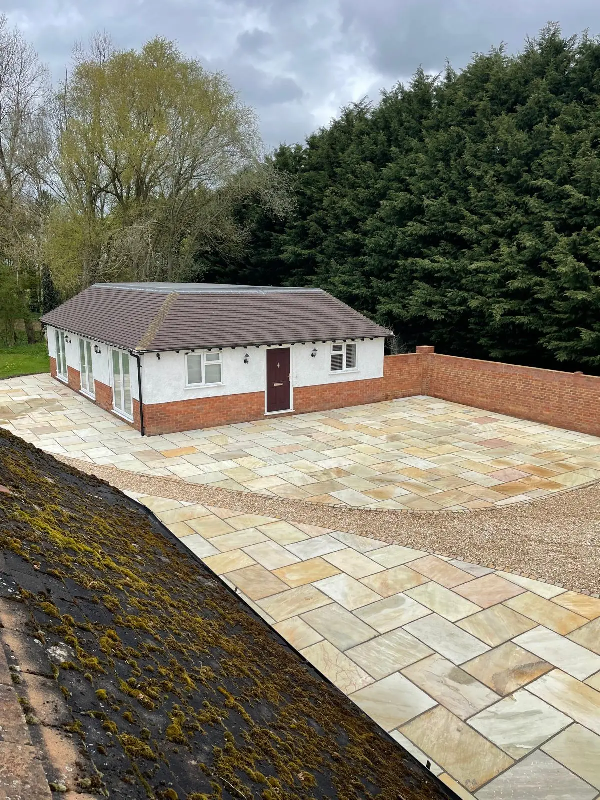New build detached bungalow with slate grey roof and Indian sandstone patio built by DBD Builders Ltd