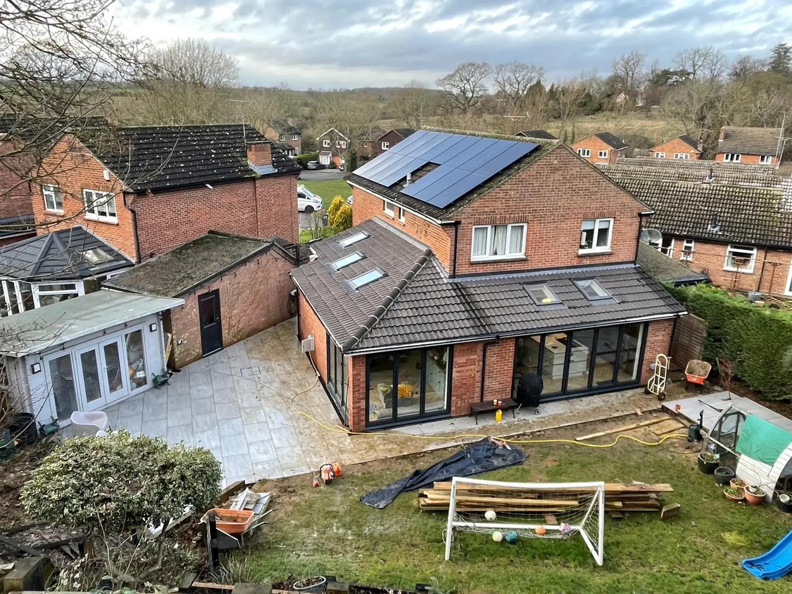 Wraparound rear extension with tiled roof, roof lights and full height aluminium glazing by DBD Builders Ltd
